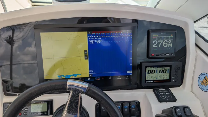 Slide: The Image of Dashboard of a 2016 Sailfish 275 DC boat with navigation and control systems. - 13
