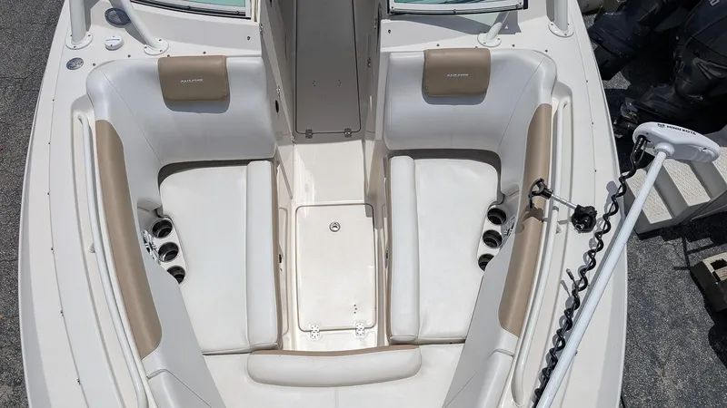 Slide: The Image of 2016 Sailfish 275 DC boat interior with white seating and cup holders. - 17