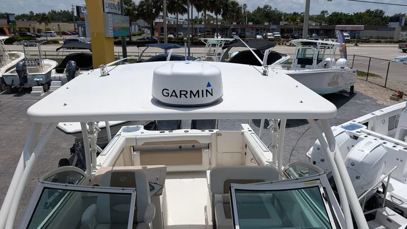 Slide: The Image of 2016 Sailfish 275 DC boat with Garmin radar, docked at a marina. - 19