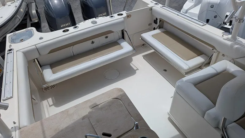 Slide: The Image of 2016 Sailfish 275 DC boat interior with seating and twin 200 engines. - 5