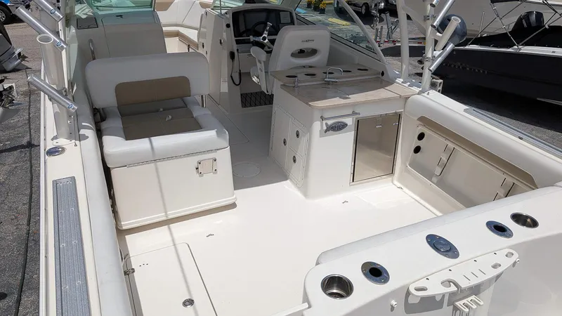 Slide: The Image of 2016 Sailfish 275 DC boat interior with seating, storage, and control panel. - 7