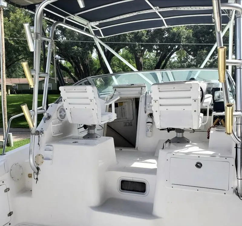 Slide: The Image of Century 3200 WA 2000 model boat interior with helm seats and canopy. - 11