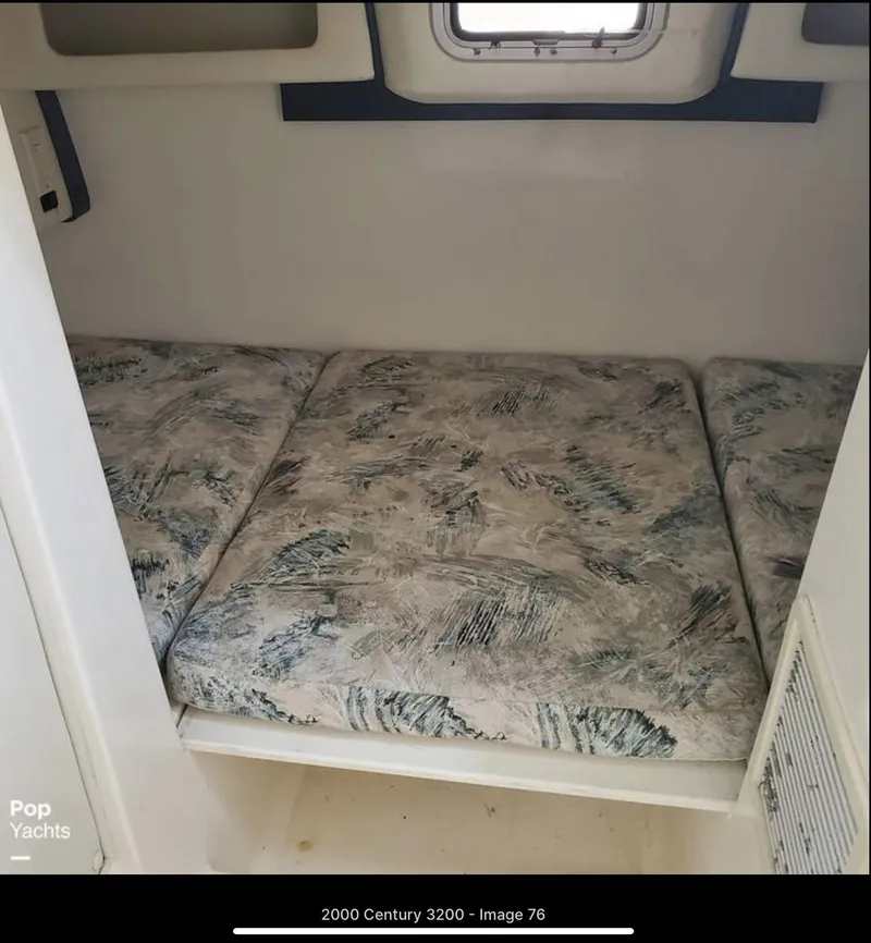 Slide: The Image of 2000 Century 3200 WA cabin interior with patterned cushions and small window. - 17
