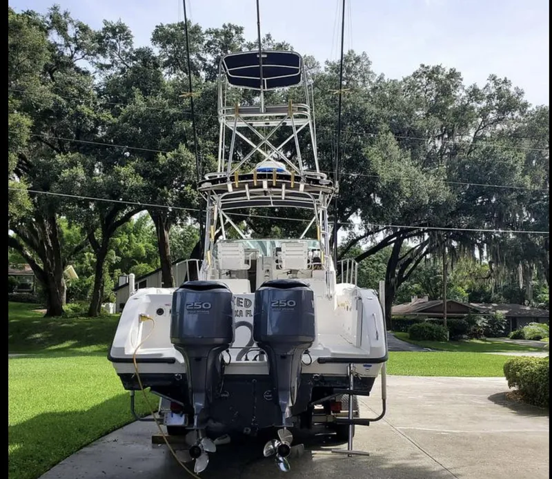 Slide: The Image of 2000 Century 3200 WA boat with dual 250 engines, parked on a driveway. - 2