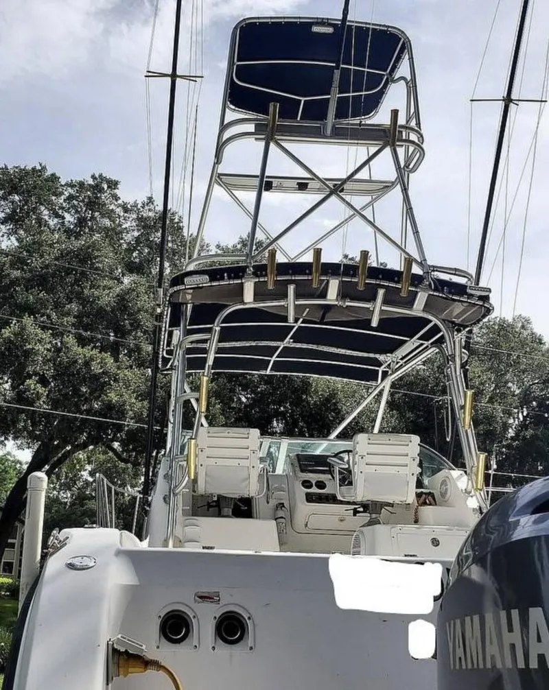 Slide: The Image of 2000 Century 3200 WA boat with dual Yamaha engines and tower, docked outdoors. - 21