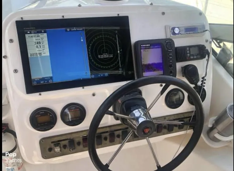 Slide: The Image of Steering console of a 2000 Century 3200 WA boat with navigation equipment and gauges. - 4