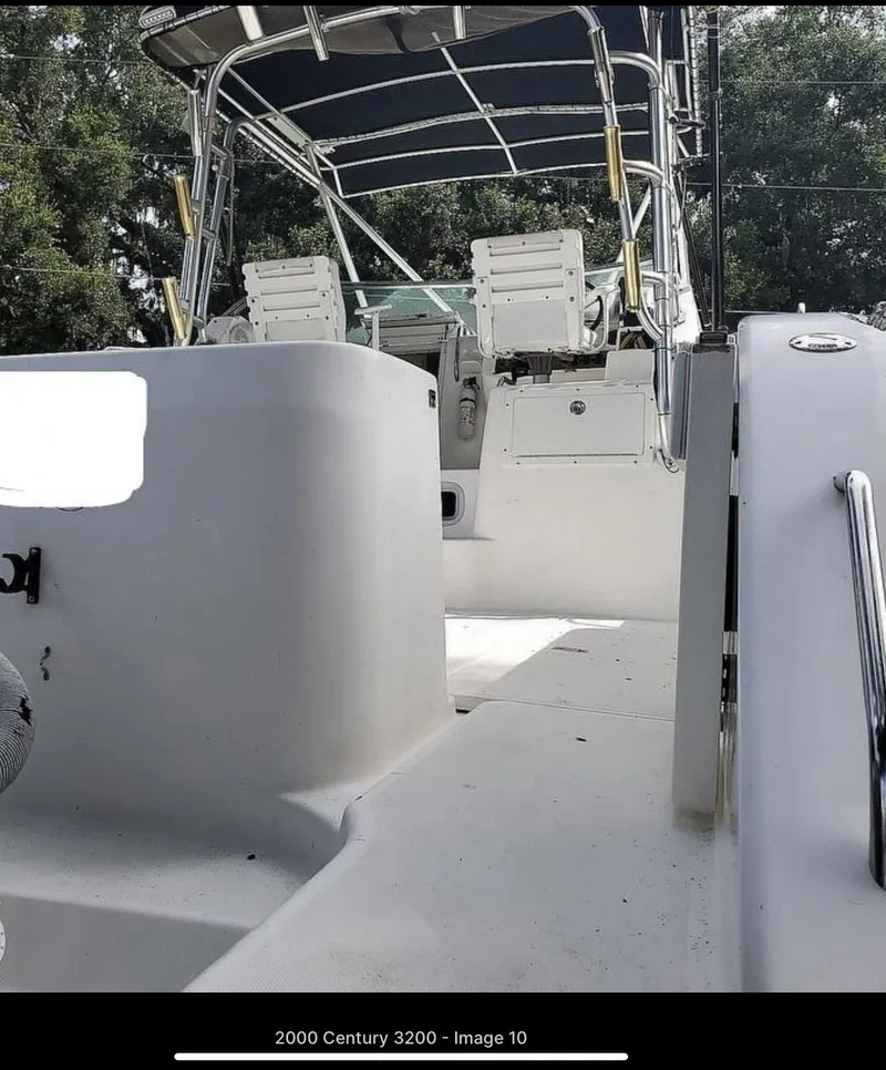 Slide: The Image of 2000 Century 3200 WA boat with seating and canopy, viewed from the deck. - 6