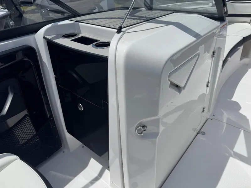 Slide: The Image of 2025 Yamaha Boats 252S interior with storage and cup holders, showcasing sleek design. - 10
