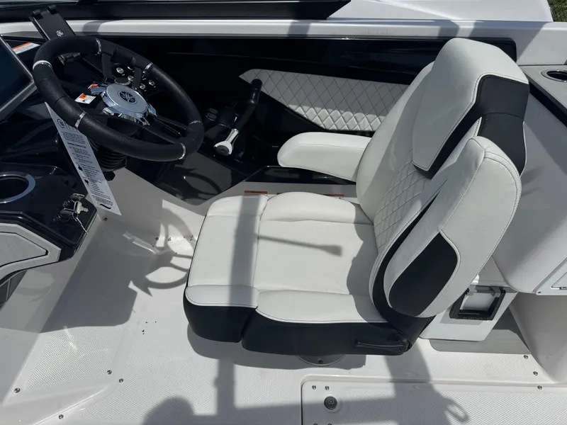 Slide: The Image of 2025 Yamaha Boats 252S cockpit with modern steering and cushioned seating. - 16