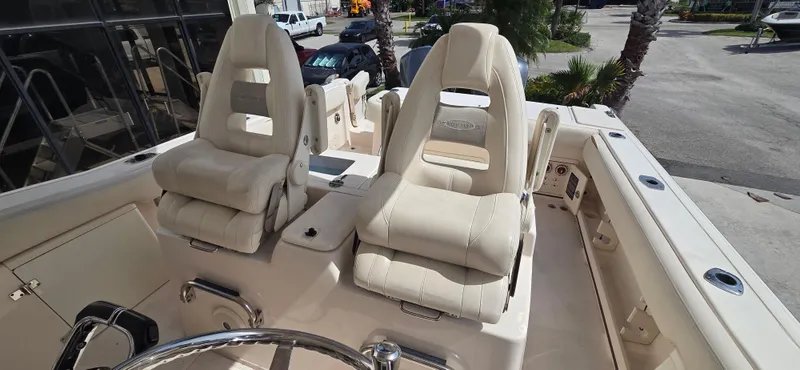 Slide: The Image of 2016 Grady-White Canyon 306 boat with plush seating and steering wheel. - 13