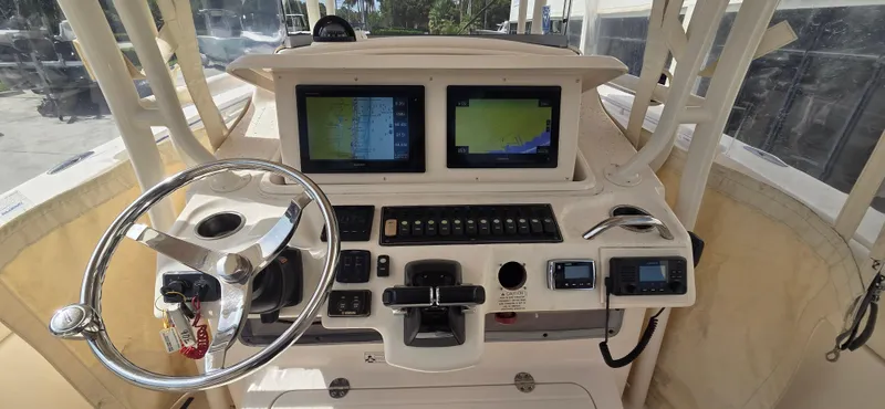 Slide: The Image of 2016 Grady-White Canyon 306 helm with dual displays and steering wheel. - 15