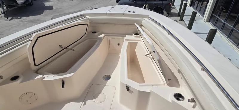 Slide: The Image of 2016 Grady-White Canyon 306 boat interior with open storage compartments. - 16