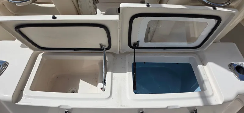 Slide: The Image of 2016 Grady-White Canyon 306 boat storage compartments open, showcasing interior features. - 17