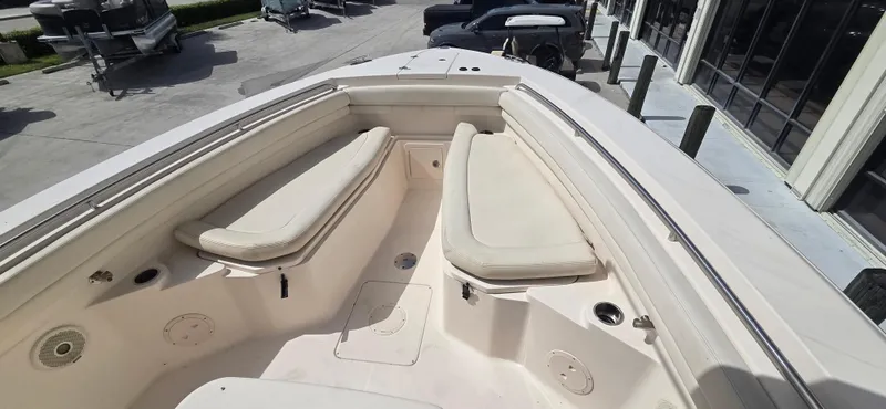 Slide: The Image of 2016 Grady-White Canyon 306 boat interior with cushioned seating and storage compartments. - 19
