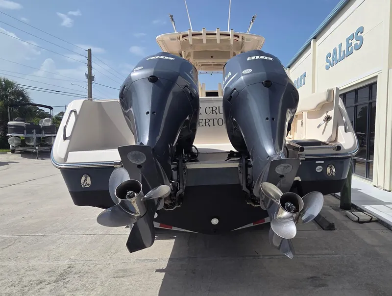 Slide: The Image of 2016 Grady-White Canyon 306 boat with dual outboard engines at a sales location. - 2