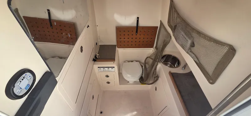 Slide: The Image of 2016 Grady-White Canyon 306 boat interior with compact bathroom amenities. - 20