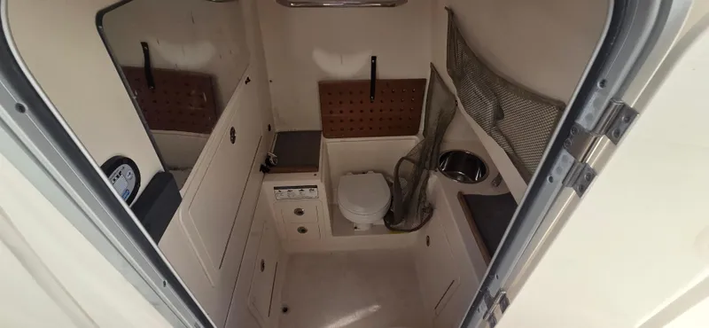 Slide: The Image of 2016 Grady-White Canyon 306 boat interior with toilet and sink. - 21
