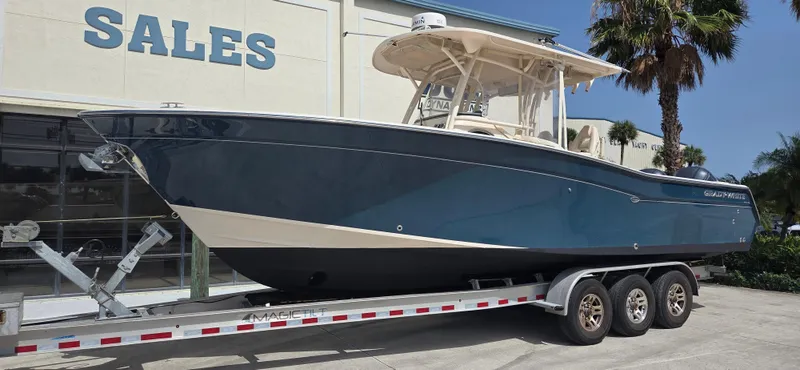 Slide: The Image of 2016 Grady-White Canyon 306 boat on trailer outside sales building. - 3