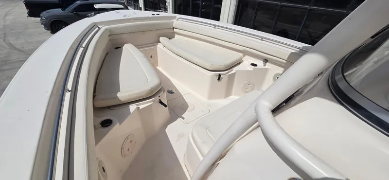 Slide: The Image of 2016 Grady-White Canyon 306 boat interior with cushioned seating and storage compartments. - 8