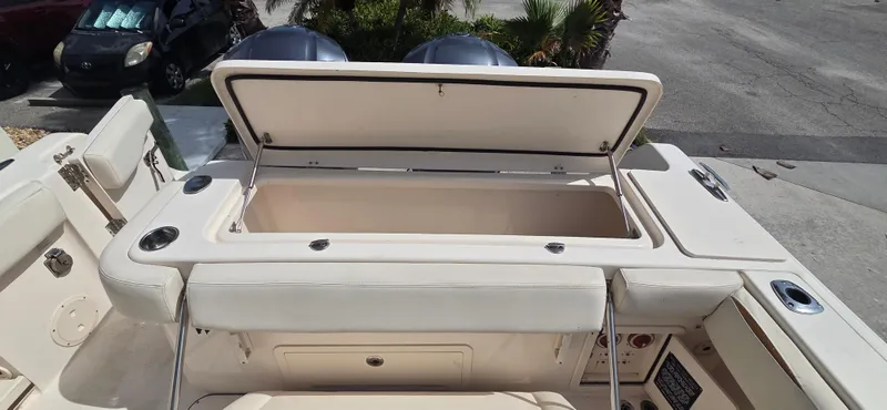 Slide: The Image of 2016 Grady-White Canyon 306 boat with open storage compartment, showcasing spacious design. - 9