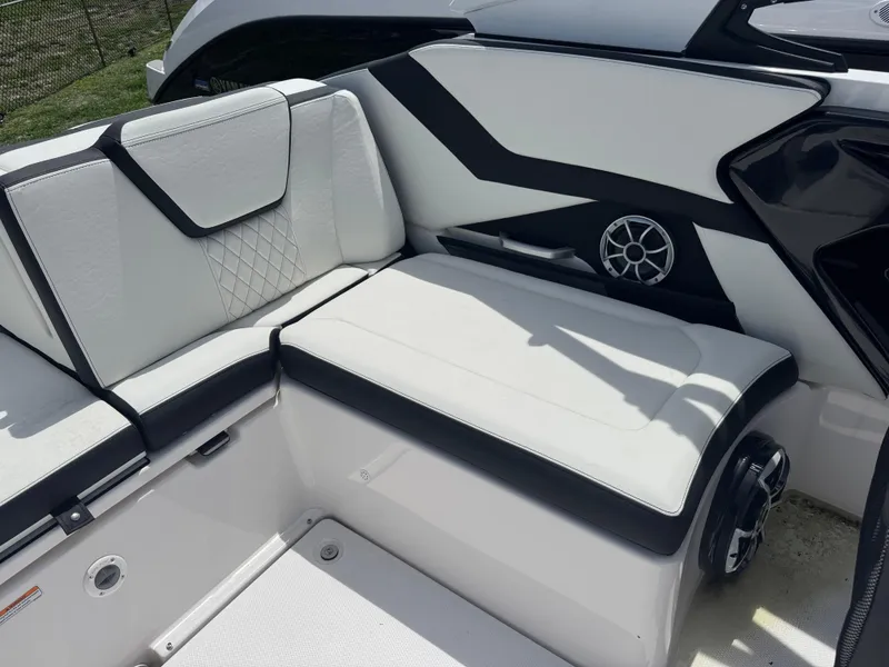 Slide: The Image of 2025 Yamaha Boats 252S interior with white and black seating, featuring modern design and speaker. - 12