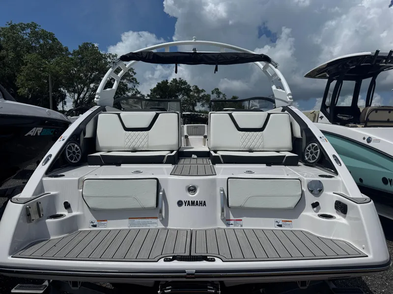 Slide: The Image of 2025 Yamaha Boats 252S with sleek design, spacious seating, and modern features under a cloudy sky. - 3