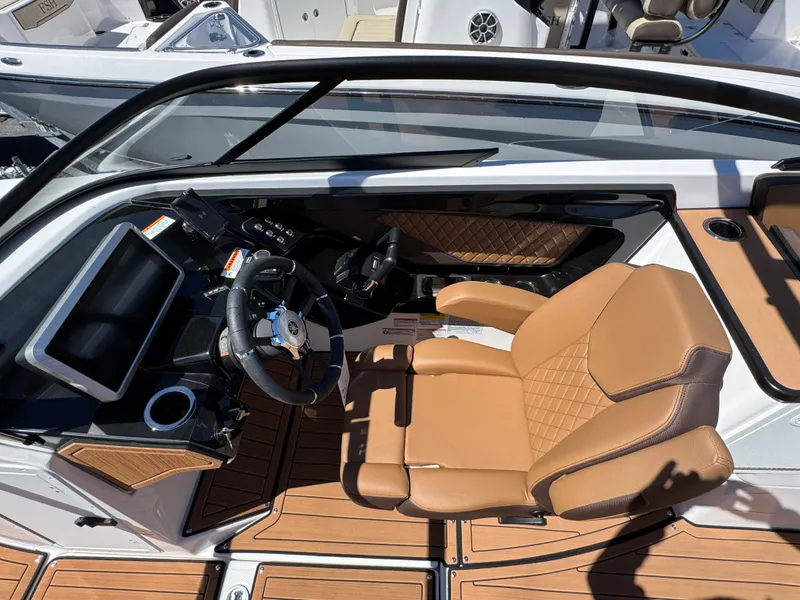 Slide: The Image of 2025 Yamaha Boats 252S cockpit with tan leather seat and modern dashboard. - 16