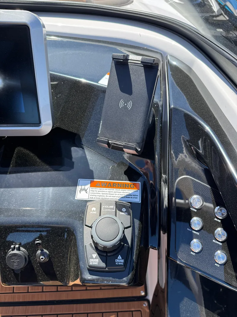 Slide: The Image of 2025 Yamaha Boats 252S dashboard with controls and wireless charging dock. - 19