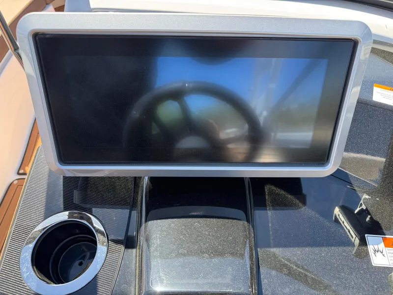 Slide: The Image of Dashboard of 2025 Yamaha Boats 252S with touchscreen and steering wheel reflection. - 20