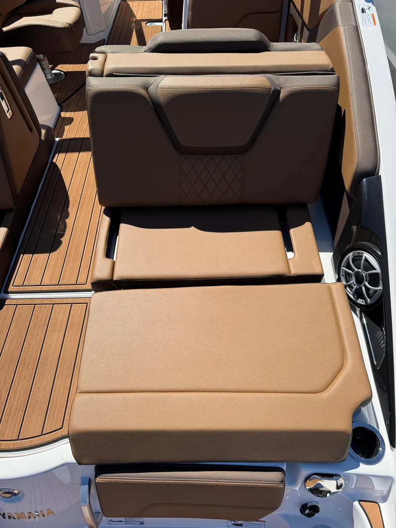 Slide: The Image of 2025 Yamaha Boats 252S interior with tan seating and wood-style flooring. - 4