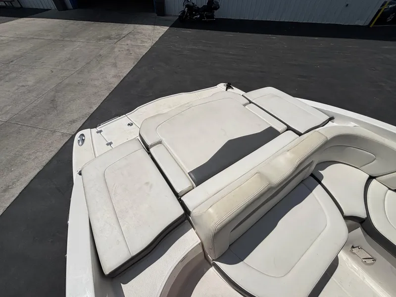 Slide: The Image of 2013 Chaparral 246 SXI boat interior with white seating and sun pad. - 15