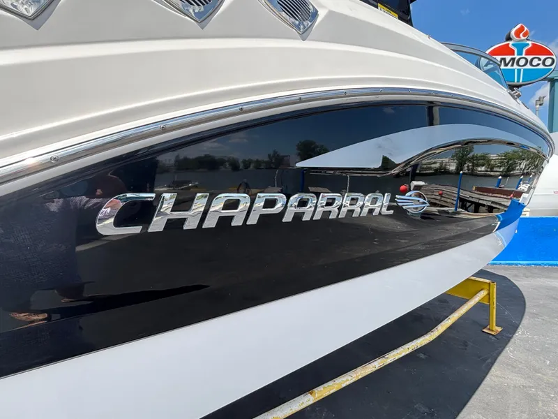 Slide: The Image of 2013 Chaparral 246 SXI boat with sleek design and chrome logo. - 17