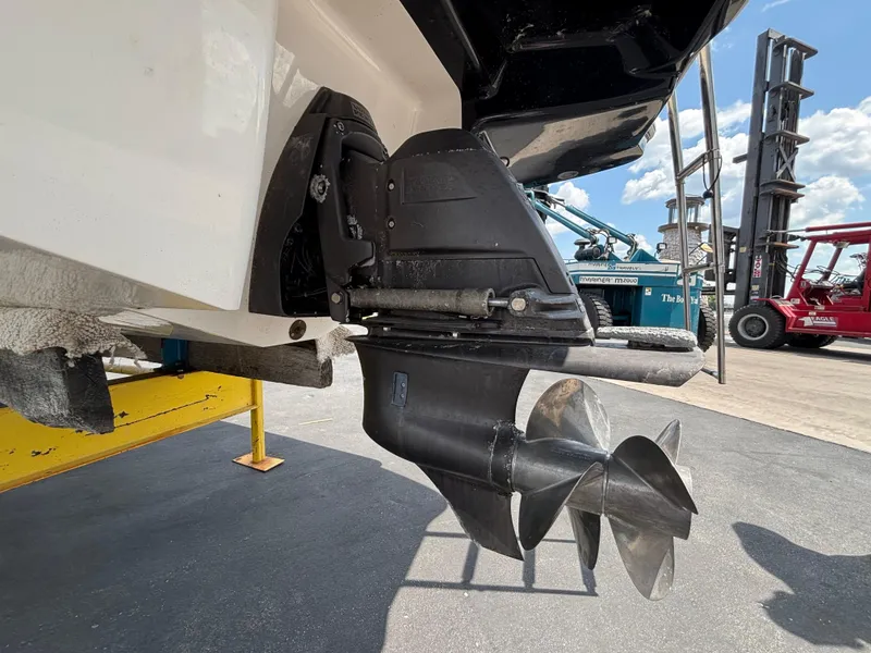 Slide: The Image of 2013 Chaparral 246 SXI boat propeller and stern drive, displayed outdoors. - 18