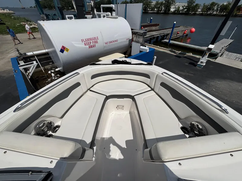 Slide: The Image of 2013 Chaparral 246 SXI boat interior at dock with fuel tank nearby. - 10