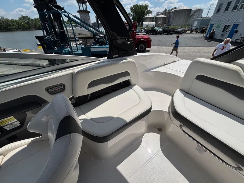 Slide: The Image of Interior of a 2013 Chaparral 246 SXI boat with seating and dockside view. - 14