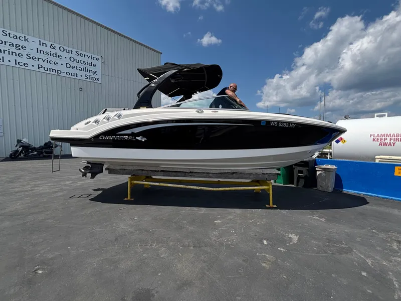 Slide: The Image of 2013 Chaparral 246 SXI boat on display at a marina service area. - 4