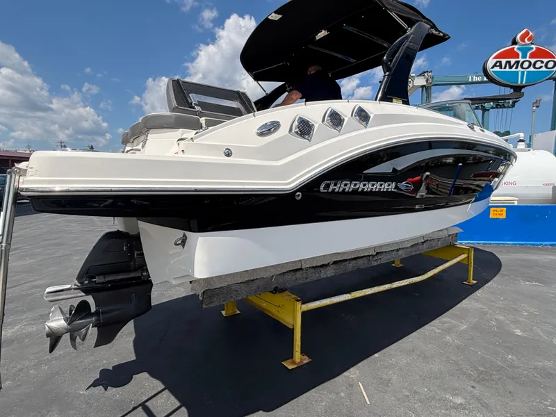 Slide: The Image of 2013 Chaparral 246 SXI boat on display at a marina with Amoco sign. - 6