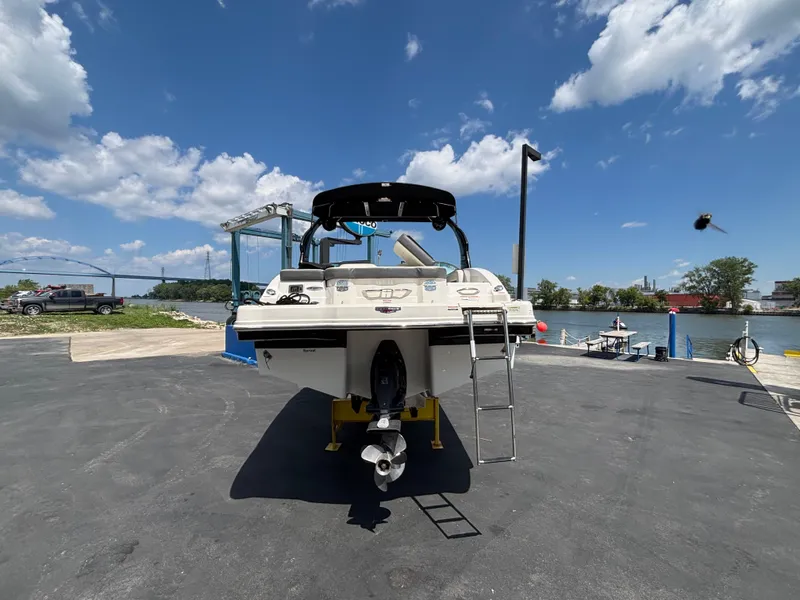 Slide: The Image of 2013 Chaparral 246 SXI boat at dock under blue sky. - 8