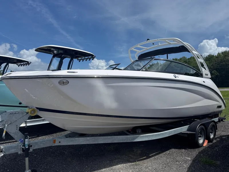 The Image of 2025 Yamaha Boats 252S on trailer under blue sky. - 1