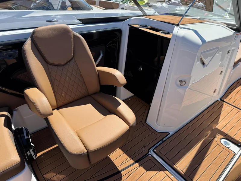 Slide: The Image of 2025 Yamaha Boats 252S interior with tan seating and wood-style flooring. - 10