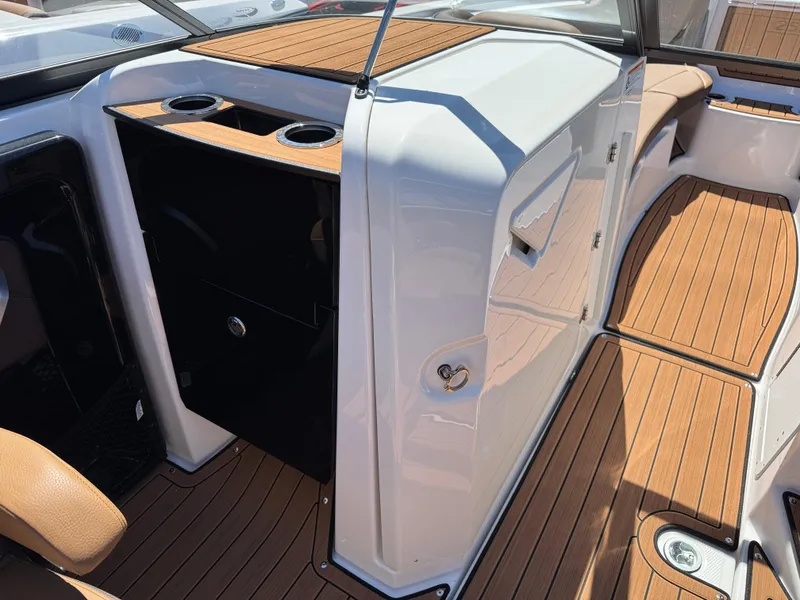 Slide: The Image of 2025 Yamaha Boats 252S interior with wood finish and cup holders. - 11