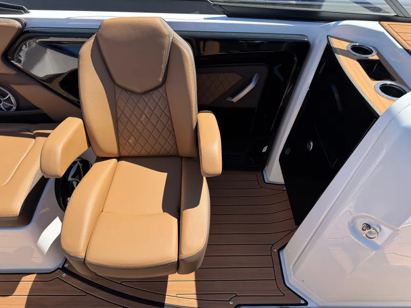 Slide: The Image of 2025 Yamaha Boats 252S interior with tan seating and wood-style flooring. - 13