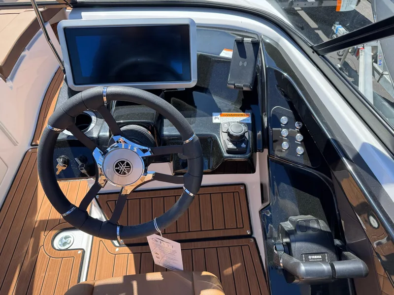 Slide: The Image of 2025 Yamaha Boats 252S dashboard with steering wheel and touchscreen display. - 17