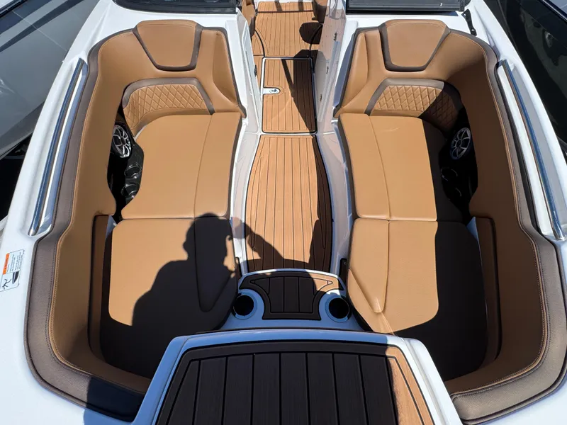 Slide: The Image of 2025 Yamaha Boats 252S interior with tan seating and wood-style flooring. - 28
