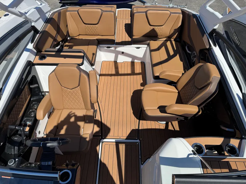 Slide: The Image of 2025 Yamaha Boats 252S interior with tan leather seating and wood-style flooring. - 30