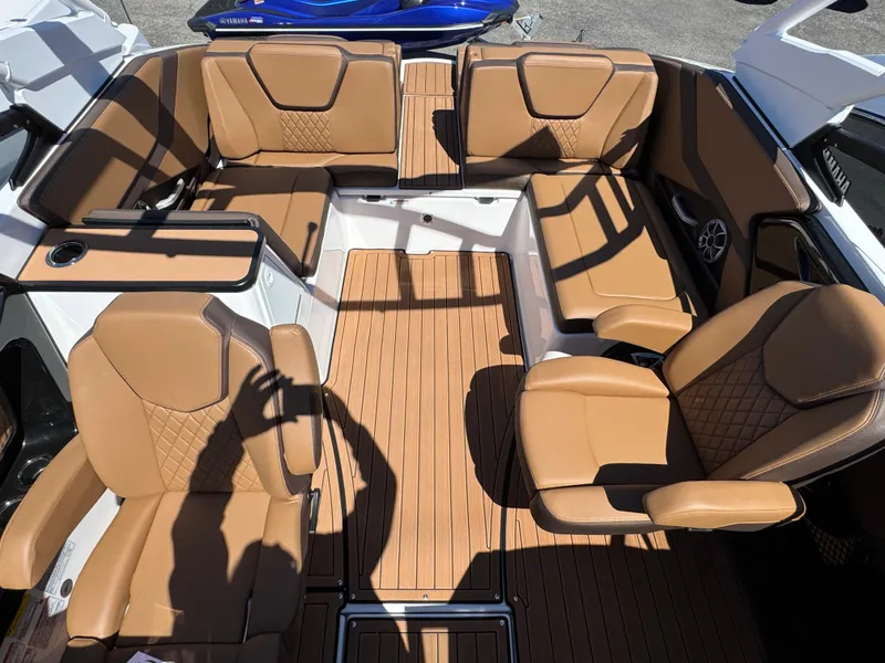 Slide: The Image of 2025 Yamaha Boats 252S interior with tan leather seating and wood-style flooring. - 31