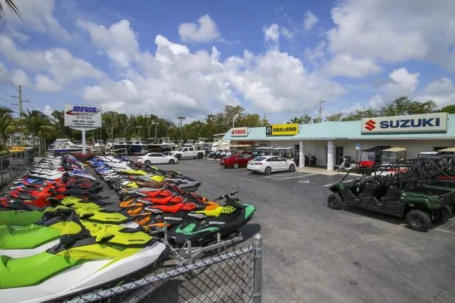 Slide: The Image of Outdoor display of colorful jet skis and off-road vehicles at a Yamaha dealership. - 10
