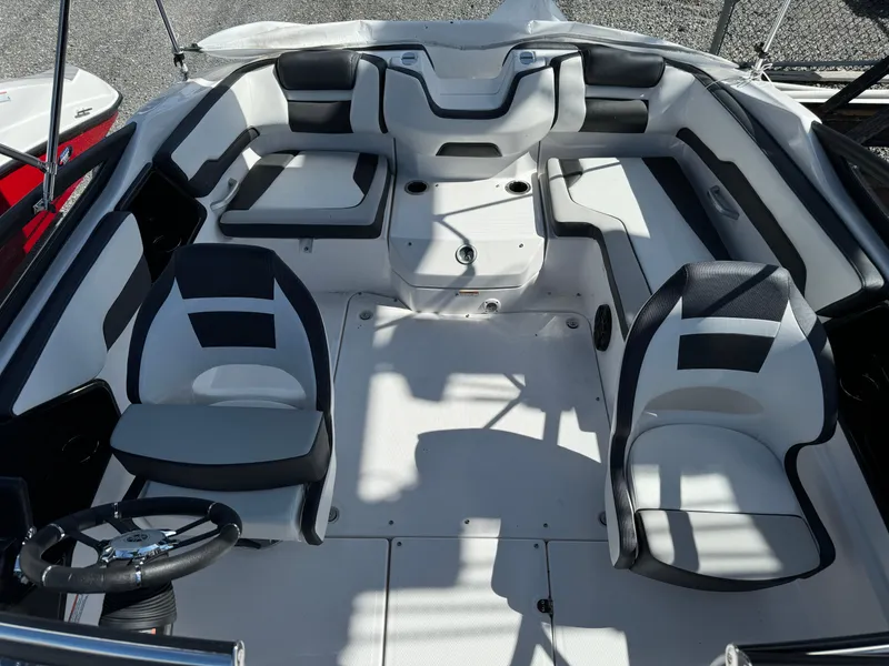 Slide: The Image of 2025 Yamaha Boats SX195 interior with modern seating and steering wheel. - 10