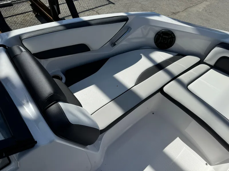 Slide: The Image of 2025 Yamaha SX195 boat interior with sleek white and black seating design. - 6