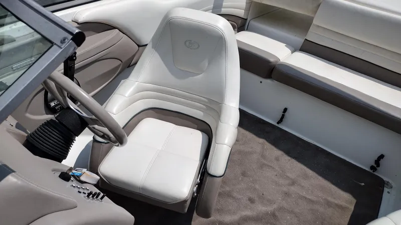 Slide: The Image of Interior seating of a 1999 Cobalt 226 boat with cup holders. - 11
